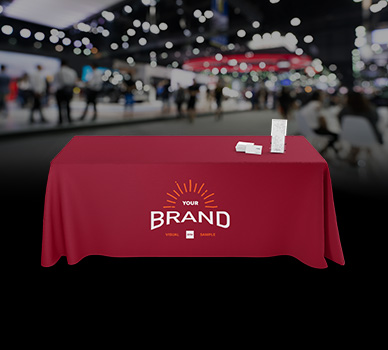Red custom event tablecloth with logo branding at a trade show – Davis Materialworks